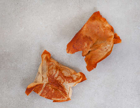 two used tea bags on mottled grey surface with copy space