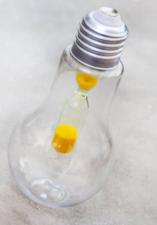 Lightbulb with hourglass, South Africa running out of time with power crisisの写真素材