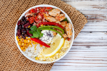 chicken buddha bowl on rustic whitewashed wooden table with copy spaceの写真素材