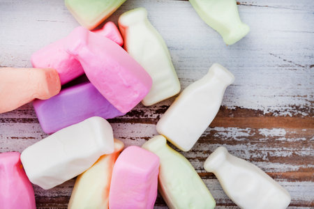Colorful old school candy, milk bottle gummies on rustic wooden surface. A favorite through the agesの写真素材