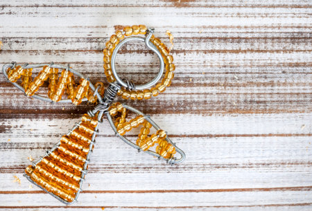 Rustic wooden flat lay, Christmas background with African beaded Christmas ornaments with copy spaceの写真素材