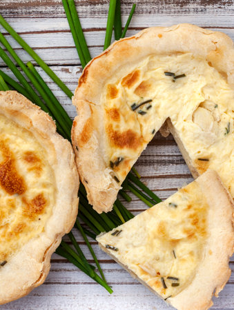 small chicken and chive Quiche sliced with fresh chives and copy space