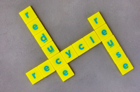 Reduce, reuse, recycle written in board game letter tiles on plain grey surfaceの写真素材