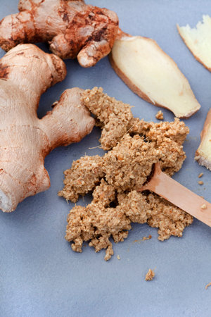 Ginger root and ginger powder on a gray background, top viewの写真素材