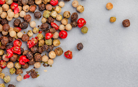 mix of peppercorns on a gray background. Top view.の写真素材
