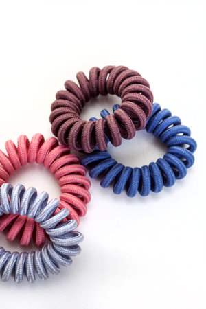 twist or invisible hair ties isolated on white in pastel colors.の写真素材