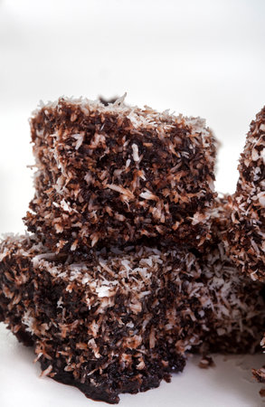 Close-up of chocolate lamingtons with coconut on white backgroundの写真素材