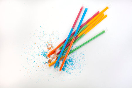Colorful kids candy sherbet filled straws on whiteの写真素材