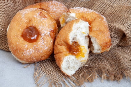 Donuts with apricot jam on sackcloth. Closeupの写真素材