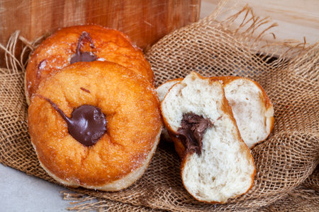 Homemade donuts with chocolate on a wooden background. Selective focus.の写真素材