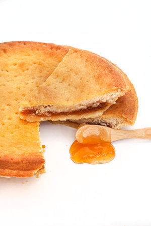 jam tart with apricot jam on a white backgroundの写真素材