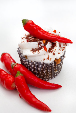 Chilli cupcakes with red hot peppers on a white background.の写真素材