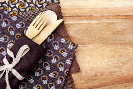 African themed table setting. Brown traditional South African Shwe Shwe cloth on woodの写真素材