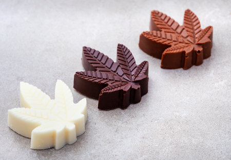 CBD infused chocolates. Delicious mood food, desserts and treats with a twist.
Dark, milk and white chocolate on grey backgroundの写真素材