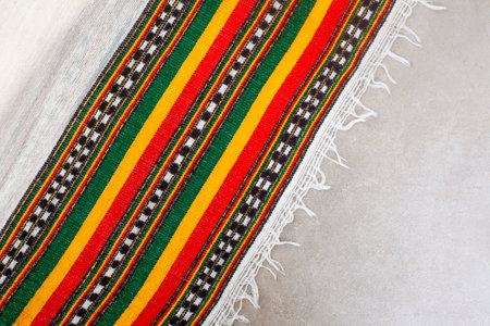 Background of cloth with Rastafarian colors on greyの写真素材
