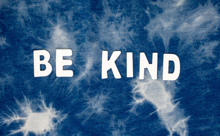 Be Kind Word on Blue Tie Dye Fabric Texture Background Great for Any Use.の写真素材