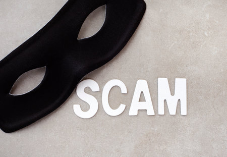 Scammers everywhere. Scam in lettering with mask on grey.