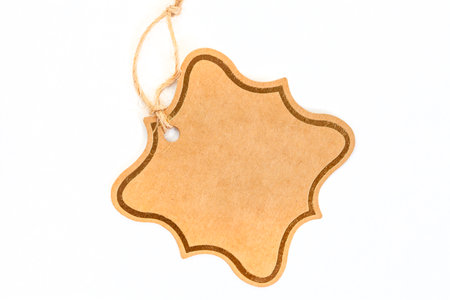 Blank cardboard gift tag isolated on plain whiteの写真素材