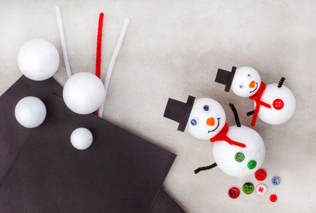 Snowman family made of polystyrene and craft supplies. Christmas and New Year background.の写真素材