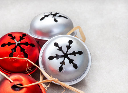 Christmas decoration with red and silver bells on a gray background, copy spaceの写真素材