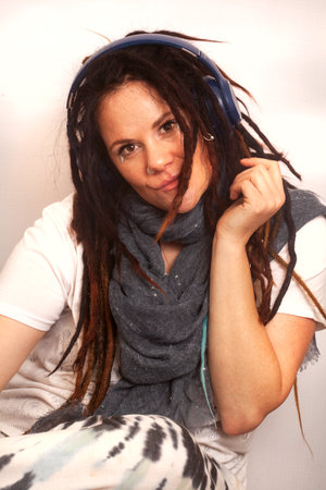 Portrait of a beautiful young woman with dreadlocks wearing headphones.の写真素材