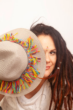 Portrait of a beautiful woman with dreadlocks wearing a straw hatの写真素材