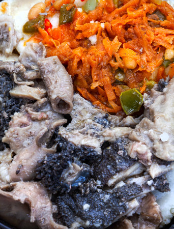 Traditional South African Mogodo or tripe stew with pap and chakalaka, close up
