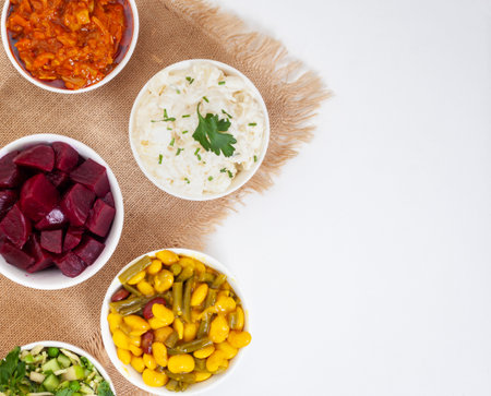 Traditional side dishes and salads for a perfect South African braai. Salads on white with Burlap...