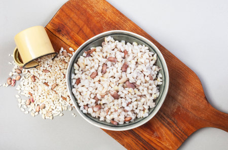 South African Samp and beans or pounded corn and kidney beans, on wooden board with cup of raw sampの写真素材