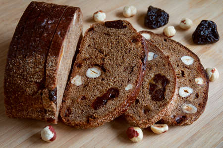 black bread with nuts and dried fruits on the tableの写真素材