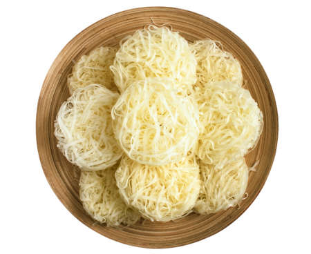 large rice noodles on a wooden plate isolate on white background