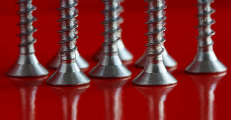 group of screws on a red backgroundの写真素材