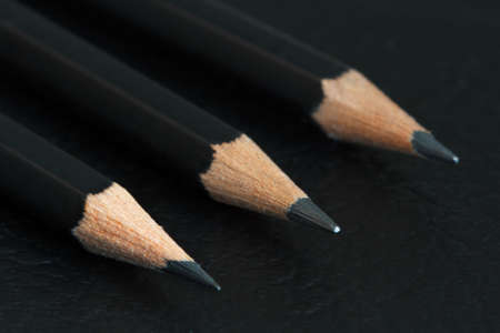 Three graphite pencils on a black backgroundの写真素材
