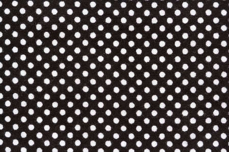 black cotton fabric with white polka dotsの写真素材