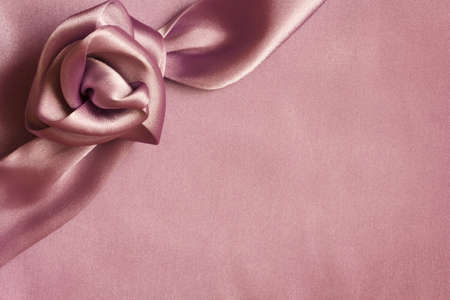 fabric flower on pink satin fabricの写真素材