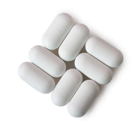 White oval pills isolated on white background