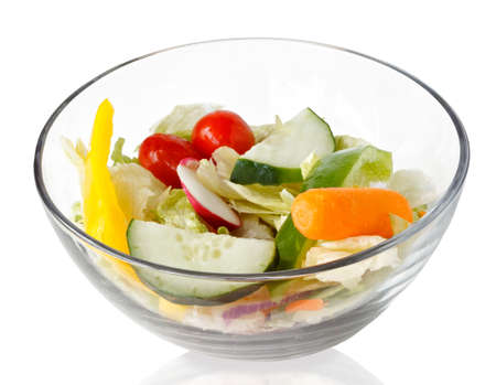fresh salad of raw vegetables  in a glass bowl isolated on white backgroundの写真素材