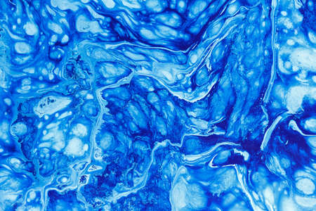 mixing paint blue white, abstract backgroundの写真素材
