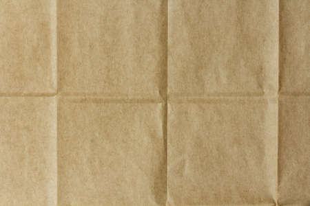 texture of crumpled brown packaging paper with foldsの写真素材