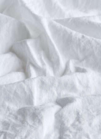 wrinkled white cotton cloth as background, shallow depth of fieldの写真素材