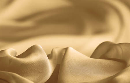 abstract background folds golden fabricの写真素材