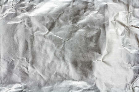 texture of crumpled aluminum foil paper based bottomの写真素材