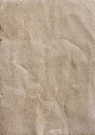 Old brown sheet of paper with spots and folds, textureの写真素材