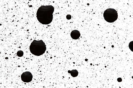 Sprays and drops of black ink on a white backgroundの写真素材
