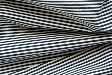 Natural cotton striped black and white fabric with large foldsの写真素材