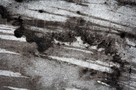 Stains and smears of  black ink on paper, abstract background, macro texture