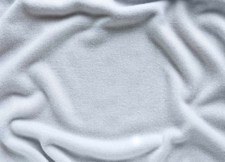 surface of a soft cashmere fabric  with large folds,  knitted background with copy spaceの写真素材