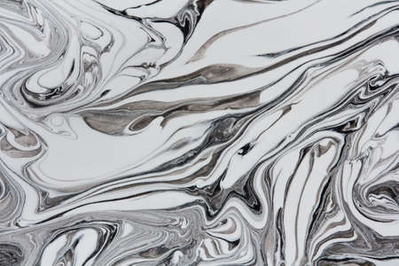 marble texture formed by mixing white and gray paints, abstract backgroundの写真素材