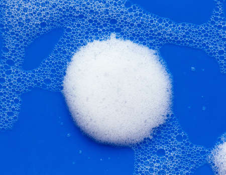 Soap foam on a bright blue background