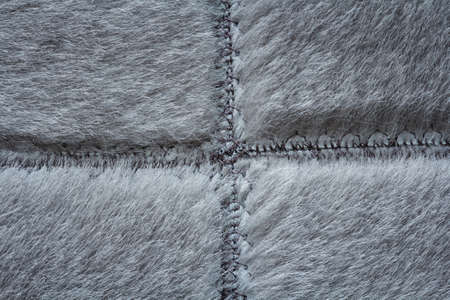 Short gray fur sewn with seams, detail of warm winter clothingの写真素材